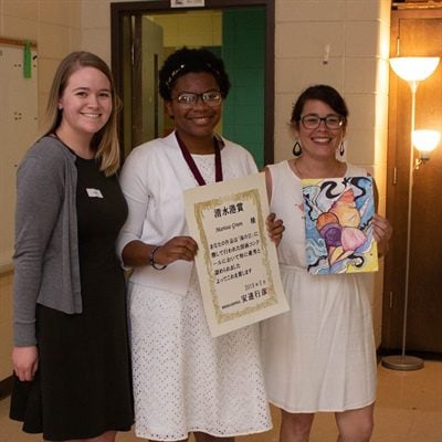 GPA Market Research Analyst Lainey Sapp, eighth-grade winner Marissa Green and Isle of Hope art teacher Magen Peigelbeck display her winning seashell painting.